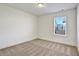 Bedroom with window view and neutral colored carpet at 2240 Mulsanne Dr, Lithonia, GA 30058