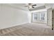 Spacious bedroom featuring a tray ceiling, ceiling fan, and lots of natural light at 2240 Mulsanne Dr, Lithonia, GA 30058