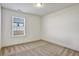 Neutral bedroom with carpet, one window, and white trim at 2240 Mulsanne Dr, Lithonia, GA 30058