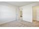 Bright bedroom featuring neutral carpet and a door to the bathroom and a walk-in closet at 2240 Mulsanne Dr, Lithonia, GA 30058