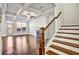 Elegant staircase leading to a spacious living area with fireplace and coffered ceilings at 2240 Mulsanne Dr, Lithonia, GA 30058