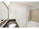 Bathroom features a granite countertop, shower with tub, and tile surround at 325 E Paces Ferry Ne Rd # 810, Atlanta, GA 30305