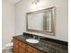 Bathroom with granite countertop, large mirror, and walk-in shower at 325 E Paces Ferry Ne Rd # 810, Atlanta, GA 30305