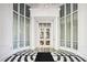 Grand building entrance featuring high ceilings, white columns, and striking black and white patterned floors at 325 E Paces Ferry Ne Rd # 810, Atlanta, GA 30305