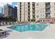 Community pool with lounge chairs, tables and umbrellas and a multi story building in the background at 325 E Paces Ferry Ne Rd # 810, Atlanta, GA 30305