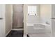 Bathroom featuring soaking tub with jets, shower and privacy window at 552 Trotters Ln, Mcdonough, GA 30252
