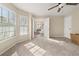 Bright bedroom featuring neutral carpet, two windows, a ceiling fan, and ample natural light at 552 Trotters Ln, Mcdonough, GA 30252