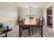 Elegant dining room featuring wainscoting, chandelier lighting, and a large dark wood table at 552 Trotters Ln, Mcdonough, GA 30252