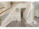 Welcoming foyer with hardwood floors, elegant staircase, and decorative wall accents at 552 Trotters Ln, Mcdonough, GA 30252