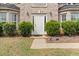 Charming entrance featuring a classic white door with sidelights and manicured landscaping at 552 Trotters Ln, Mcdonough, GA 30252