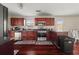 Cozy kitchen featuring stainless steel appliances, dark wood cabinets, and hardwood flooring at 552 Trotters Ln, Mcdonough, GA 30252
