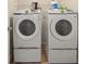 Laundry room featuring side-by-side white washer and dryer units for convenience at 552 Trotters Ln, Mcdonough, GA 30252