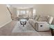 Comfortable living room featuring neutral tones, plush seating, and abundant natural light at 552 Trotters Ln, Mcdonough, GA 30252