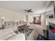 Spacious living room with neutral tones, fireplace, and plush sofa with view to kitchen and dining area at 552 Trotters Ln, Mcdonough, GA 30252