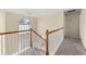 Carpeted staircase with white railings leading to the upper level, lit by a large arched window at 552 Trotters Ln, Mcdonough, GA 30252