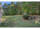 Spacious backyard with lush green grass and mature trees, offering privacy and serenity at 5623 Yeager Dr, Douglasville, GA 30135