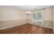 Dining room featuring modern chandelier, wood floor, and large bright window at 5623 Yeager Dr, Douglasville, GA 30135