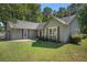 Charming grey home with well-manicured lawn, dark shutters, and a red front door at 5623 Yeager Dr, Douglasville, GA 30135