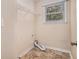 Laundry room features tile floors, a window, and wire shelving at 5623 Yeager Dr, Douglasville, GA 30135