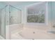 Bathroom features a shower with glass door and a separate bathtub at 5623 Yeager Dr, Douglasville, GA 30135
