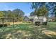 View of home with screened in porch and a lush yard with mature trees at 5623 Yeager Ridge Dr, Douglasville, GA 30135