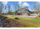 Backyard view featuring a patio and a well-maintained yard with an outdoor firepit at 168 Jersey Rd, Oxford, GA 30054