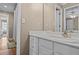 Bathroom with a vanity sink, mirror, and white cabinets for storage at 168 Jersey Rd, Oxford, GA 30054