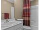 Cozy bathroom featuring a vanity sink, toilet, and a shower and bathtub combination at 168 Jersey Rd, Oxford, GA 30054