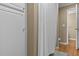 White bathroom with tub and shower combination and plenty of linen storage at 168 Jersey Rd, Oxford, GA 30054