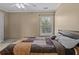 Bedroom with a queen size bed, ceiling fan, and lots of natural light from the window at 168 Jersey Rd, Oxford, GA 30054