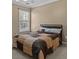 Bedroom with neutral walls, ceiling fan, and natural light from the large window at 168 Jersey Rd, Oxford, GA 30054