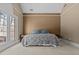 Large bedroom showcasing a tray ceiling, neutral walls, and private outdoor access at 168 Jersey Rd, Oxford, GA 30054