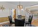 Inviting dining area featuring hardwood floors and a unique light fixture at 168 Jersey Rd, Oxford, GA 30054