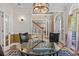 Bright dining room with wood floors, elegant light fixture, and round glass-top table at 168 Jersey Rd, Oxford, GA 30054