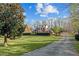 Beautiful brick home, featuring a lush lawn and a winding driveway at 168 Jersey Rd, Oxford, GA 30054