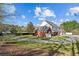 Rear exterior view of home with circle drive, patio, and grassy lawn at 168 Jersey Rd, Oxford, GA 30054