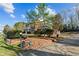 Elegant brick home with mature landscaping, retaining wall, and a circular driveway at 168 Jersey Rd, Oxford, GA 30054