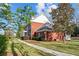 Two-story brick home with well-manicured lawn and sidewalk leading to the front entrance at 168 Jersey Rd, Oxford, GA 30054