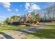 Beautiful red brick home featuring lush green lawn and manicured shrubbery at 168 Jersey Rd, Oxford, GA 30054