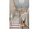 Gracious foyer with hardwood floors, elegant staircase, and a chandelier at 168 Jersey Rd, Oxford, GA 30054