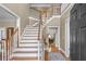 Grand foyer with hardwood floors, elegant staircase, and high ceilings at 168 Jersey Rd, Oxford, GA 30054