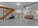Spacious garage featuring an adjacent staircase and storage cabinets with a comfortable seating area at 168 Jersey Rd, Oxford, GA 30054