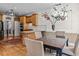 Bright kitchen with wood cabinets, granite countertops and stainless steel appliances; adjacent breakfast nook with a table and seating at 168 Jersey Rd, Oxford, GA 30054