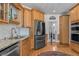 Bright kitchen with stainless steel appliances, granite countertops, and wood cabinets at 168 Jersey Rd, Oxford, GA 30054