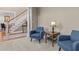 Inviting living room with plush chairs and view of the staircase at 168 Jersey Rd, Oxford, GA 30054