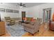Relaxing living room with hardwood floors, plush seating, and a ceiling fan at 168 Jersey Rd, Oxford, GA 30054
