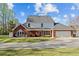 Rear view of home featuring a patio area, garage, and manicured lawn at 168 Jersey Rd, Oxford, GA 30054