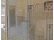 Detailed shot of the tiled shower with glass door and built in shower niche at 168 Jersey Rd, Oxford, GA 30054