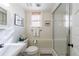 Neutral bathroom featuring a tiled shower with glass door and a black and white tiled floor at 202 Lakeview Ave, Atlanta, GA 30305
