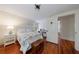 Bedroom features hardwood floors, closet, white trim, and a comfortable bed with a decorative quilt at 202 Lakeview Ave, Atlanta, GA 30305